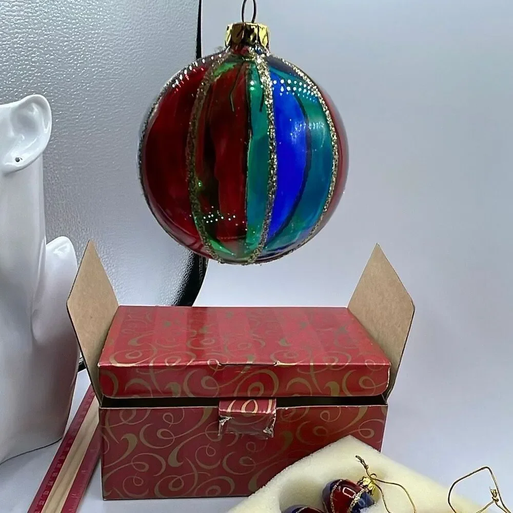 Vintage Avon 2001 Holiday Treasures blown glass ornaments.